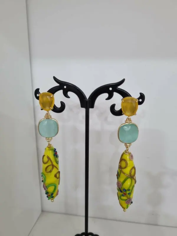Earrings made with cat's eye and decorated blown glass