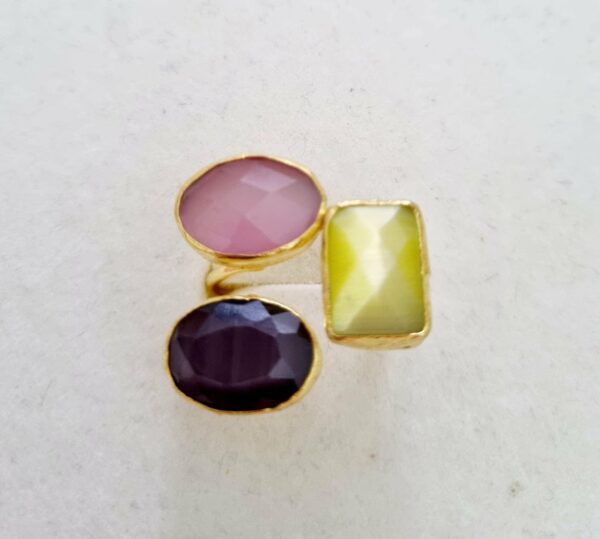 Adjustable ring made with a trio of cat's eye stones and brass