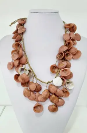 Necklace made with pink and white resin shells on cord. Button closure. Adjustable length 60 cm