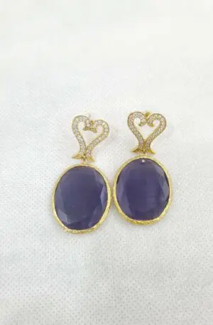 Earrings made with purple cat's eye and brass pin with zircons. Length 5cm