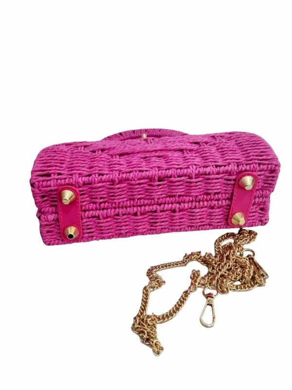 Bag made of fabric and eco-leather inserts, equipped with golden shoulder strap, lined interior with open side pocket. Base with studs. Measurements L23 H17 B6.5 Fuchsia colour