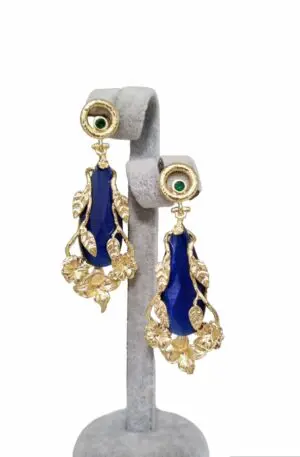 Earrings made with blue cat's eye surrounded by brass leaves. Brass pin with green zircon. Weight 11.1g Length 7cm