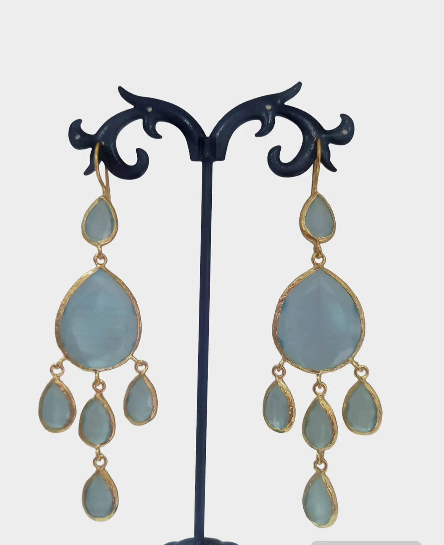 Earrings made with cat's eye drops surrounded by brass. Color sea water Length 8.5cm Weight 7.7gr