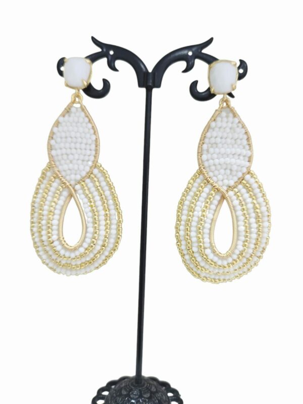 Orecchini realizzati artigianalmente con cristalli swarovski e perline dorate. Perno in agata bianca.lunghezza 7.5cmpeso 7.2gr Spedizione Gratuita