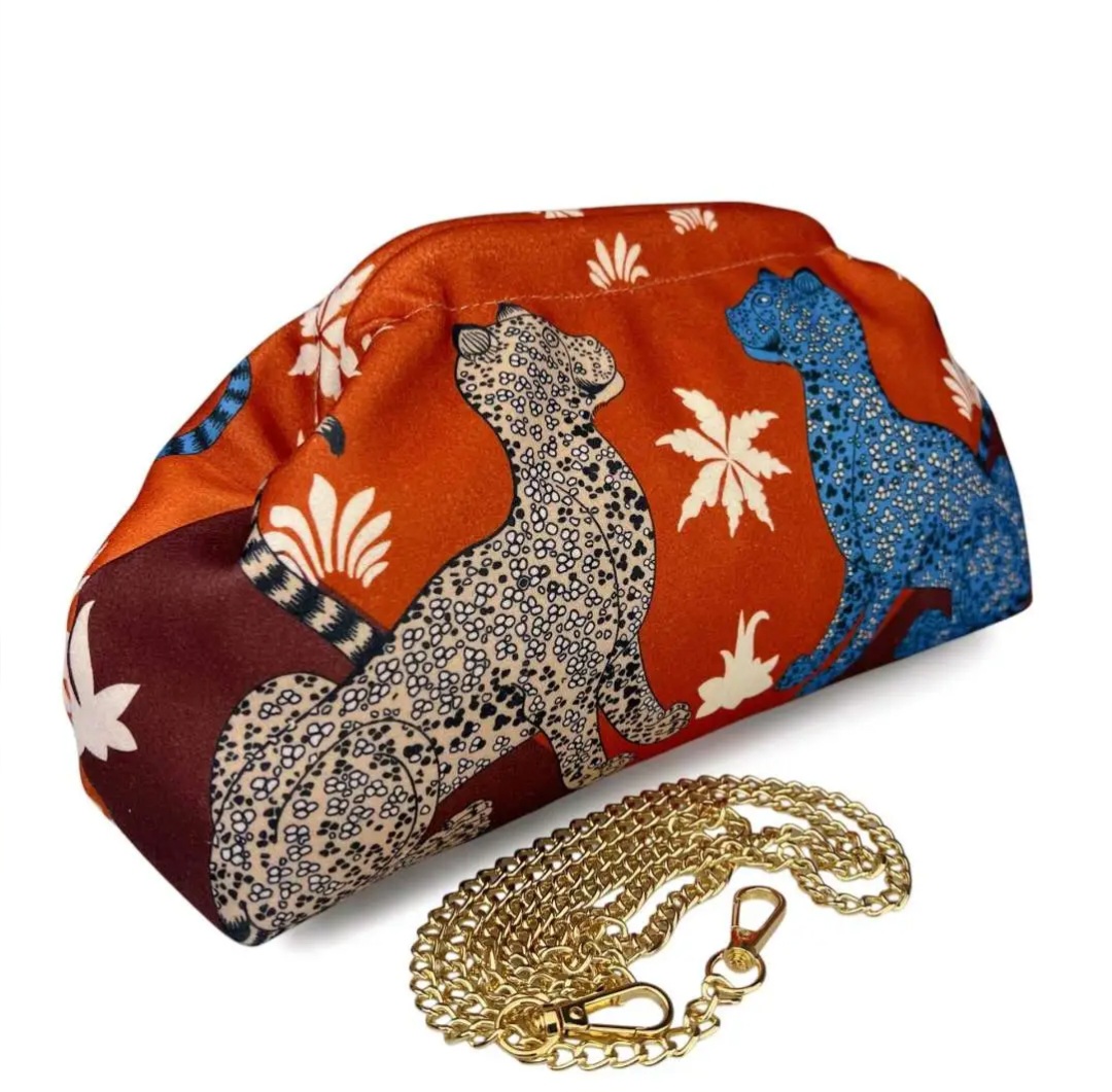 Pochette in tessuto con leopardi, ,dotata di catenella dorata,interno nudo. Misure L31 H18
colore arancio Spedizione Gratuita